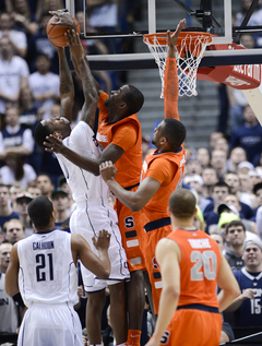 Syracuse center Baye Moussa Keita blocks Connecticut forward Phillip Nolan.