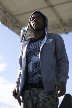 Kendrick Lamar takes a break from his set and looks out at the crowd.