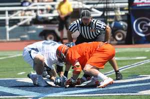 Syracuse's Chris Daddio and Villanova's Thomas Croonquist prepare to fight for a faceoff in the Orange's 13-9 win over the Wildcats in the Big East tournament championship game on Saturday. As a team, Syracuse won 11 of 26 faceoffs. 