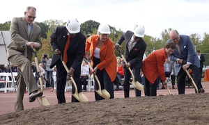 SU officials dig into the foundation of the new football practice facility on Sunday to celebrate the beginning of its construction. The facility is located at Lower Coyne Field on the Lampe Athletic Complex. The 102,258-square foot structure costs $13 million and will be completed in about 8 to 9 months. The complex will include a field named after John Phelan, WWII veteran and father of SU benefactor Jean Thompson.