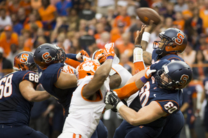 Terrel Hunt attempts to get a pass off over the stiff Clemson pass rush. The Syracuse quarterback completed just eight passes for 52 yards.