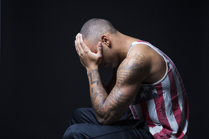 Frank Santos displays his intricate sleeve, which features flags representing his roots, 31 stars to signify his date of birth and the New York City skyline, sketched by Santos.