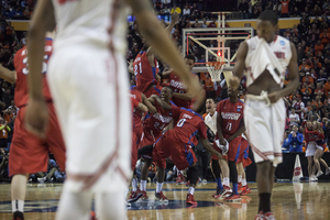 Dayton players celebrate after knocking off Ohio State in the second round of the NCAA Tournament on Thursday. The Flyers rotate at least nine players regularly.