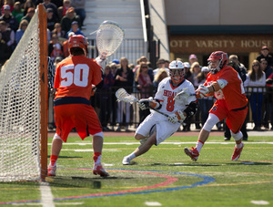 Jordan Evans (right) defends Hobart's Zach Reed as he dodges toward the Syracuse cage. 