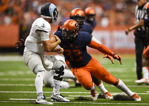 Marqez Hodge goes in for a tackle of Rhode Island quarterback Paul Mroz.