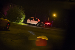 Syracuse Police Department officers and dogs survey the area around Robert Drive in search of the suspects in the shooting on Hope Avenue.