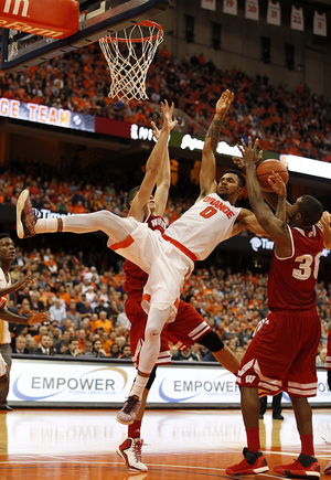 Gbinije gets fouled by Brown and another Wisconsin player as he goes up to the rim.