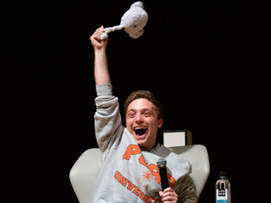 Jake Shane twirls a purple octopus (or puss) in the air after first coming out onto the Goldstein Auditorium stage. Shane was hosted by the University Union in  “A Conversation with Jake Shane.”