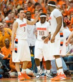 Johnny Flynn (10) receives congratulations from teammates Andy Rautins (1) and Arzine Onuaku (21) during No. 23 Syracuse's 98-94 win over Georgetown Saturday. Flynn scored 25 points, eclipsing the 1,000 point mark in his career during the victory.