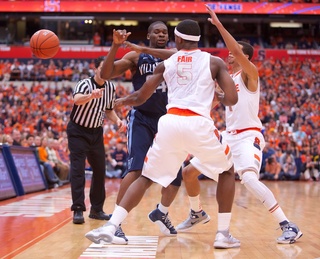 Syracuse forward CJ Fair (5) and point guard Michael Carter-Williams force a turnover by Villanova's Achraf Yacoubou.