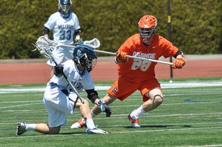 Syracuse long-stick midfielder Peter Macartney defends a Villanova scorer.