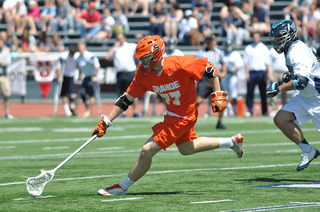 Syracuse midfielder Henry Schoonmaker picks up a ground ball.