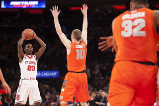 Trevor Cooney defends Rysheed Jordan in the first half.