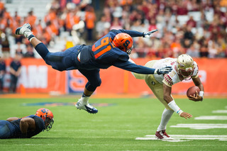 Syracuse defensive lineman Isaiah Johnson flies through the air to take down Winston. 