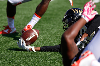 A Wake Forest player reaches out to add a couple more inches to his play. 