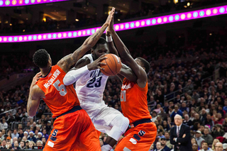 Ochefu attempts to split McCullough and Roberson. Villanova was held to only 31 points in the first half.