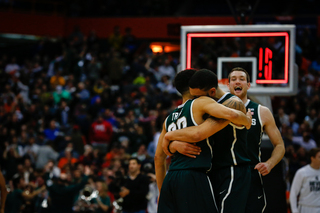 Denzel Valentine, center, embraces Travis Trice, left, as Michigan State defeats Oklahoma 62-58.