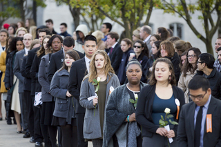 Remembrance Scholars stood on the sidewalks on both sides of the Remembrance Wall as they prepared to place their roses on the wall.