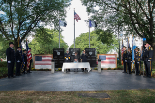 Syracuse Mayor Stephanie Miner, flanked by other officials, stands in silence to remember the Sept. 11 attacks.