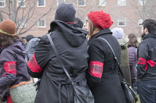 Scattered throughout the attentive audience were splashes of red, the color of the International Women’s Strike. 