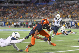 Taj Harris lunges for more yards after a reception.