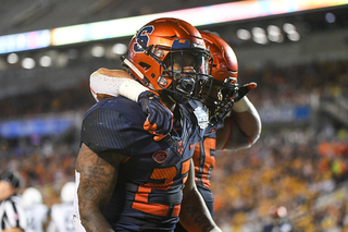 Running back Abdul Adams and fullback Chris Elmore celebrate after one of Adams' two touchdowns. 