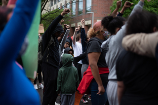 Protesters stood together, fists up in solidarity.