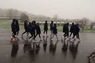 To show their support for Black athletes, administrators, coaches and students, the SU volleyball team marches together through the snow.