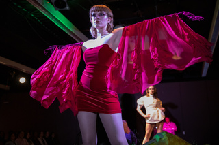 Ceinwen Gibbons poses with arms out at the FADS “Abiotic Wanderers” fashion show in the Shine Underground.