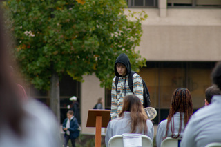 A student passing by the ceremony pauses to read the plaque listing the names of the 35 students who died on the flight. Many stopped to watch the scholars honor the victims during the 35 minutes of sitting. 